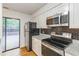 Well-lit kitchen features granite countertops, modern appliances, and hardwood floors with access to the rear patio at 127 Finley Forest Dr, Chapel Hill, NC 27517