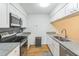 A kitchen with stainless steel appliances, white cabinets, granite countertops, and a stainless steel sink at 127 Finley Forest Dr, Chapel Hill, NC 27517
