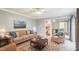 A furnished living room with hardwood floors, a large sofa, accent chairs and an area rug at 127 Finley Forest Dr, Chapel Hill, NC 27517