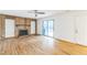 An empty living room featuring hardwood floors, a fireplace, built in shelving, and a glass sliding door at 127 Finley Forest Dr, Chapel Hill, NC 27517
