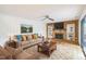 A living room featuring hardwood floors, a fireplace, built in shelving, and a large sofa at 127 Finley Forest Dr, Chapel Hill, NC 27517