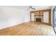 An empty living room with hardwood floors, a fireplace, built in shelving, and a ceiling fan at 127 Finley Forest Dr, Chapel Hill, NC 27517