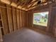 Bedroom framing with a large window showcasing the neighborhood's serene atmosphere and exterior view at 136 Tuskeegee Dr, Smithfield, NC 27577
