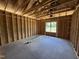 Unfinished bedroom shows framing and a window, offering a blank canvas for customization and design at 136 Tuskeegee Dr, Smithfield, NC 27577