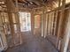 Open-concept living room area showing the wooden frames with visible insulation and concrete flooring at 136 Tuskeegee Dr, Smithfield, NC 27577