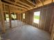Bright living room showcasing exposed wood framing with concrete flooring and scenic outdoor views from its window at 136 Tuskeegee Dr, Smithfield, NC 27577