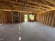 Spacious living room area with wood framing, concrete flooring, and a window showcasing beautiful outdoor view at 136 Tuskeegee Dr, Smithfield, NC 27577