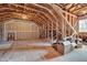 Unfinished attic space with exposed wooden beams, drywall and a window at 137 Cofield Cir, Durham, NC 27707