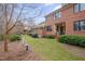 Backyard brick home with lush landscaping, windows and a covered patio at 137 Cofield Cir, Durham, NC 27707
