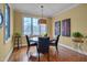 Bright breakfast nook with large window, hardwood flooring, and stylish light fixture at 137 Cofield Cir, Durham, NC 27707
