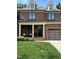Charming brick townhouse featuring a two-car garage and welcoming front porch seating at 137 Cofield Cir, Durham, NC 27707