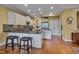 Elegant kitchen featuring stainless appliances, granite counters, and hardwood floors at 137 Cofield Cir, Durham, NC 27707