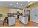 Bright kitchen with stainless steel appliances, center island, and hardwood floors at 137 Cofield Cir, Durham, NC 27707