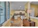 View of the spacious white kitchen, featuring granite counters and hardwood flooring at 137 Cofield Cir, Durham, NC 27707