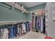 This large walk-in closet with shelving and hanging rods provides lots of storage space at 137 Cofield Cir, Durham, NC 27707