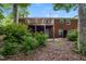 Backyard featuring a deck, brick siding, and lush greenery at 1405 Kenbrook Dr, Garner, NC 27529
