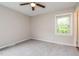 Cozy bedroom with neutral paint, carpeted floors, a ceiling fan, and a window with natural light at 1405 Kenbrook Dr, Garner, NC 27529