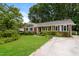 Charming one story home with brick accents, black shutters, established shrubs and manicured lawn at 1405 Kenbrook Dr, Garner, NC 27529