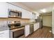 Well-lit kitchen featuring stainless steel appliances, granite countertops and modern cabinetry at 1405 Kenbrook Dr, Garner, NC 27529