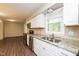 Modern kitchen with granite countertops, stainless steel appliances, and white cabinetry at 1405 Kenbrook Dr, Garner, NC 27529