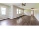 Inviting living room featuring wood-look flooring and a built in bookcase at 1405 Kenbrook Dr, Garner, NC 27529