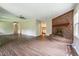 Spacious living room with hardwood floors and a charming brick fireplace at 1405 Kenbrook Dr, Garner, NC 27529
