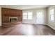 Inviting living room featuring a brick fireplace and abundant natural light at 1405 Kenbrook Dr, Garner, NC 27529