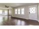 Bright living room featuring wood-look flooring, large windows, and fresh neutral paint at 1405 Kenbrook Dr, Garner, NC 27529