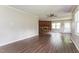 Spacious living room featuring wood-look floors and a charming brick fireplace at 1405 Kenbrook Dr, Garner, NC 27529