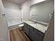 Bathroom showcasing shower/tub, toilet, vanity, granite countertop, mirror and attractive wood look floors at 152 Tulipfield Way, Benson, NC 27504
