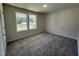 Bedroom featuring neutral carpeting and two double hung windows providing ample natural light at 152 Tulipfield Way, Benson, NC 27504