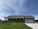 Charming single-story home features a welcoming front porch and attached two-car garage at 152 Tulipfield Way, Benson, NC 27504