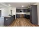 Modern kitchen boasts sleek gray cabinetry, granite countertops, and stainless steel appliances at 152 Tulipfield Way, Benson, NC 27504