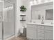 Bathroom featuring a glass enclosed shower and double sink vanity at 157 N District Ave # 291, Clayton, NC 27527