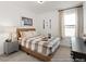 Cozy bedroom featuring a plaid coverlet, baseball decor and lots of natural light at 157 N District Ave # 291, Clayton, NC 27527