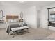 Bedroom featuring a large window, a platform bed, and a seating bench at 157 N District Ave # 291, Clayton, NC 27527