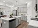 Open concept kitchen featuring stainless steel appliances and gray cabinetry with island and pendant lights at 157 N District Ave # 291, Clayton, NC 27527