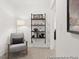 Comfortable sitting area featuring a stylish chair, a lamp, and a decorative shelving unit at 157 N District Ave # 291, Clayton, NC 27527