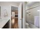 Bright bathroom with shower and toilet and sink area leads to a bedroom with fireplace at 1602 Township Cir, Raleigh, NC 27609