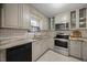 Well-equipped kitchen featuring stainless steel oven, microwave, ample cabinets, and stylish countertops at 1602 Township Cir, Raleigh, NC 27609