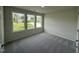 Bedroom with a view from three windows overlooking the front yard and gray carpet at 171 Tulipfield Way, Benson, NC 27504