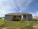 The back of the home has a deck and steps down to the backyard at 171 Tulipfield Way, Benson, NC 27504