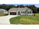 Charming one-story home with a brown garage door and a beautifully landscaped front yard at 171 Tulipfield Way, Benson, NC 27504