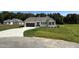 Inviting one-story home with a well-manicured lawn and a convenient driveway leading to the garage at 171 Tulipfield Way, Benson, NC 27504