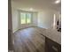 Bright breakfast nook with large windows, wood-look floors, and a view of the living room fireplace at 171 Tulipfield Way, Benson, NC 27504
