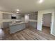 Modern kitchen with granite countertops, grey cabinets, stainless steel appliances, and a spacious island at 171 Tulipfield Way, Benson, NC 27504