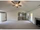Cozy living room showcasing a fireplace, hardwood floors, and an open layout to the kitchen and dining area at 171 Tulipfield Way, Benson, NC 27504