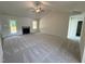 Spacious living room with a cozy fireplace, vaulted ceilings, and ample natural light from the windows at 171 Tulipfield Way, Benson, NC 27504