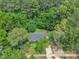 Aerial view of a home surrounded by lush trees and a driveway at 1717 Martin Luther King Jr Blvd, Raleigh, NC 27610