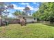 The backyard features green grass, a wooden deck, mature trees, and a wooden fence at 1717 Martin Luther King Jr Blvd, Raleigh, NC 27610